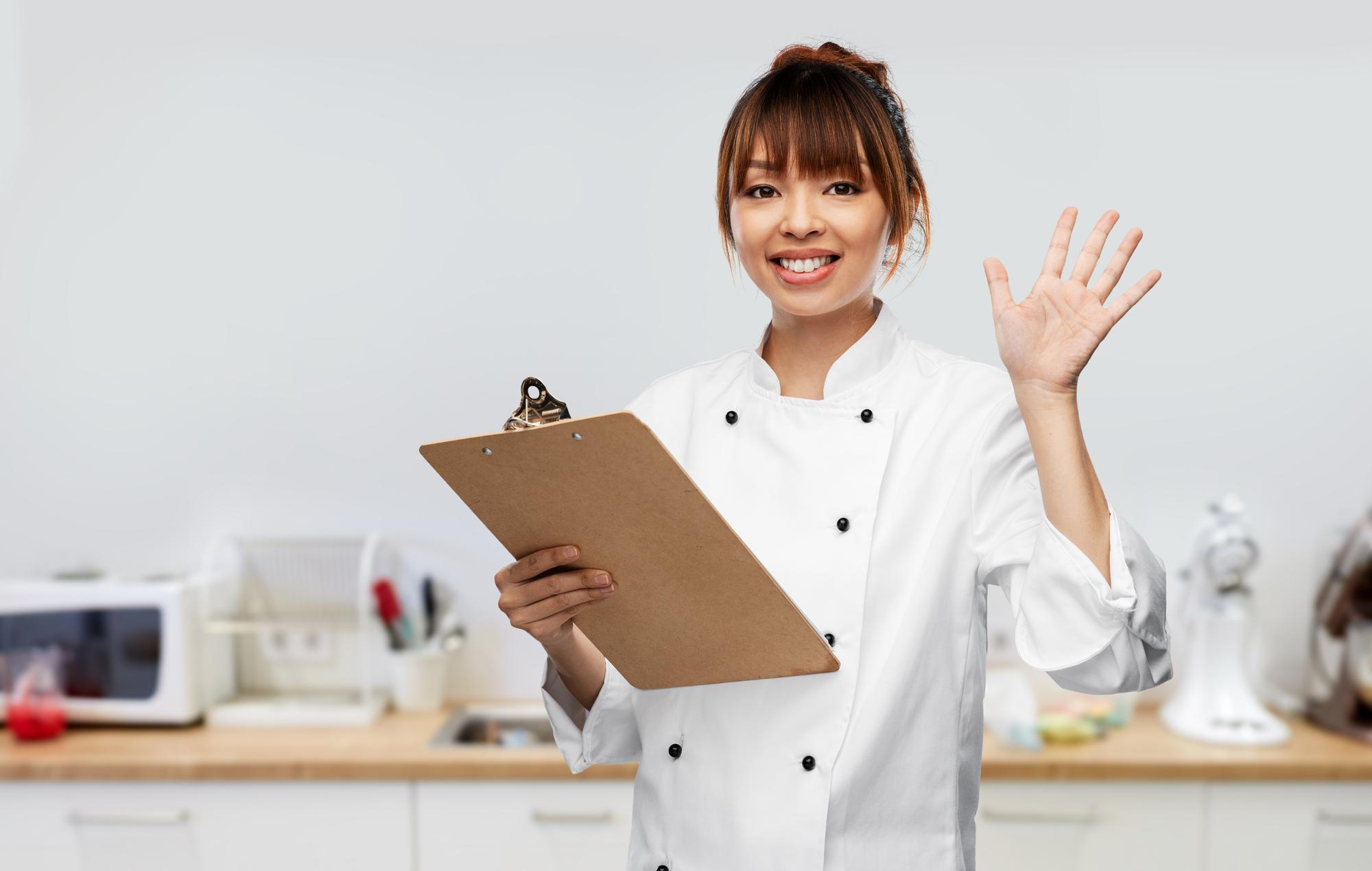 Friendly chef greeting clients in a modern kitchen